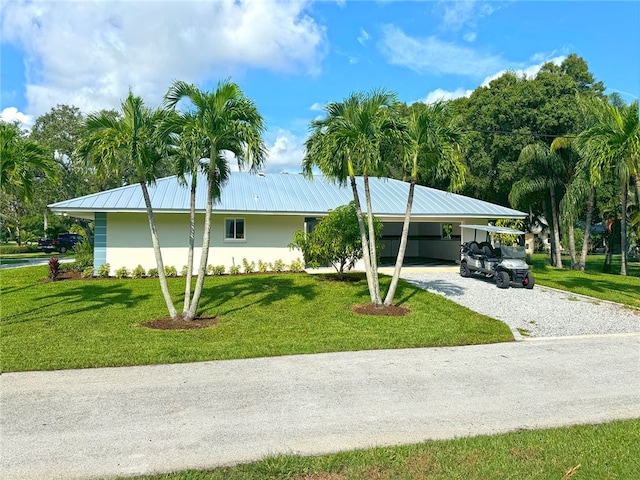 ranch-style house with a carport and a front yard