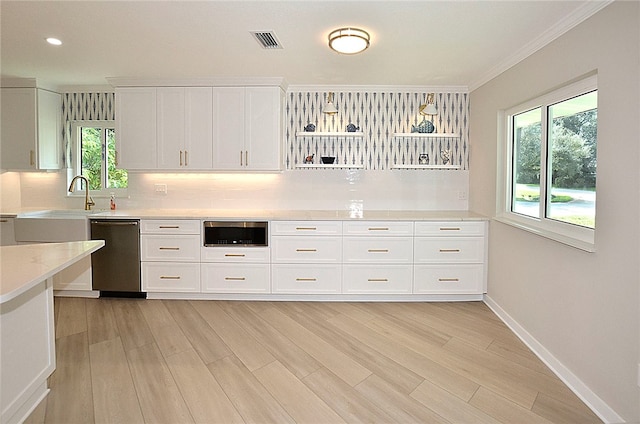 kitchen featuring white cabinets, dishwasher, light wood-type flooring, and plenty of natural light