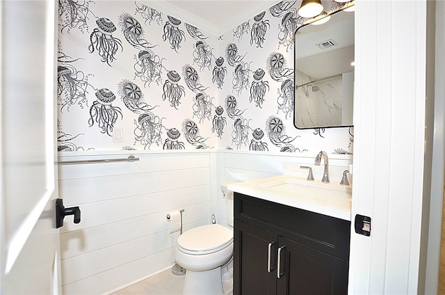 bathroom featuring vanity, ornamental molding, and toilet