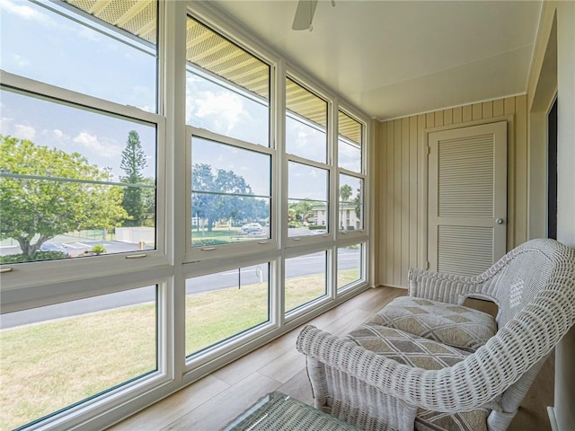 sunroom with ceiling fan and wood finished floors