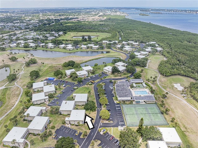 aerial view of property's location featuring a large body of water and nearby suburban area