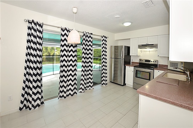 kitchen with pendant lighting, appliances with stainless steel finishes, white cabinets, and sink