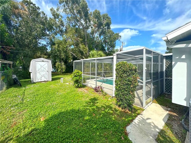 view of yard featuring glass enclosure and a storage shed