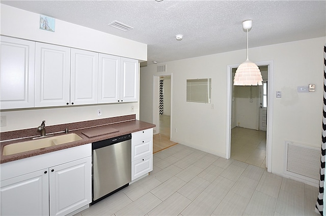 kitchen with dishwasher, pendant lighting, sink, and white cabinets