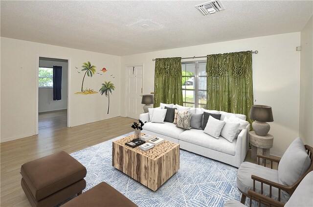 living room featuring a textured ceiling and light wood-type flooring