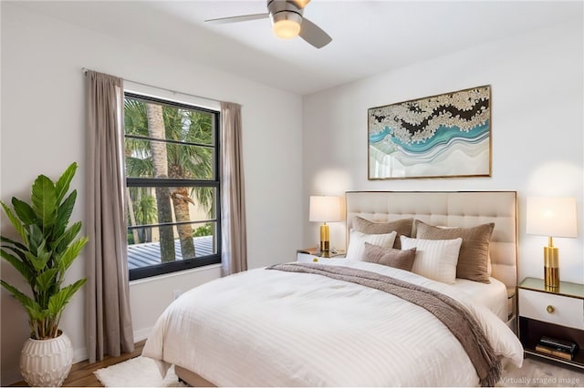 bedroom with wood-type flooring and ceiling fan