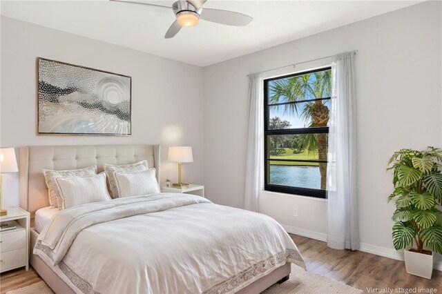 bedroom featuring light hardwood / wood-style floors and ceiling fan