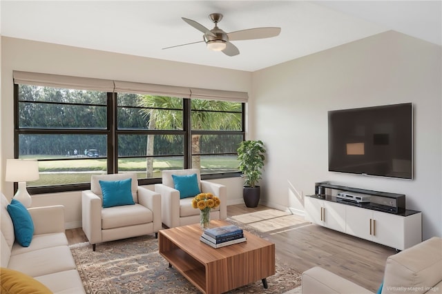 living room with ceiling fan and light hardwood / wood-style flooring