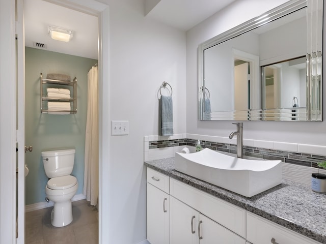 bathroom featuring tile patterned flooring, vanity, and toilet