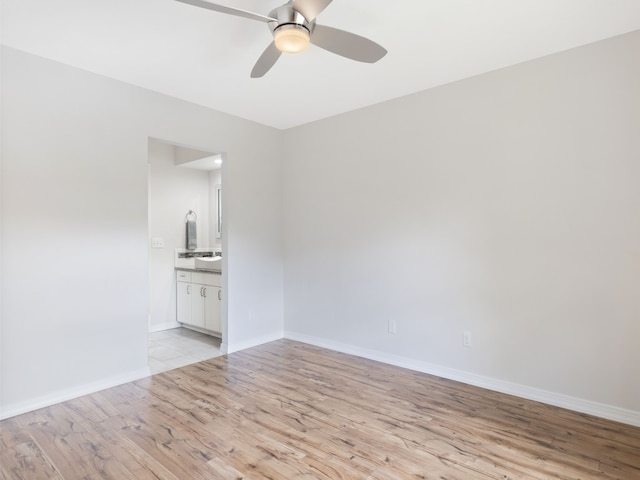 empty room with ceiling fan and light wood-type flooring