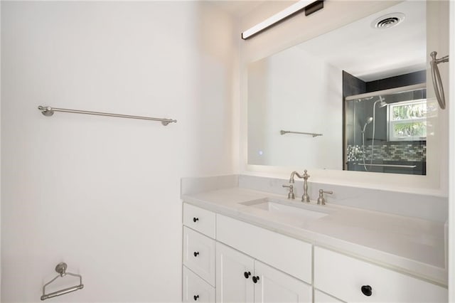 bathroom featuring an enclosed shower and vanity