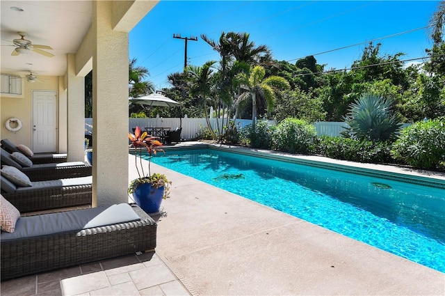 view of pool with a patio and ceiling fan