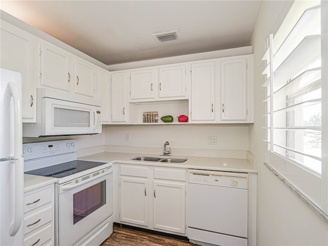 kitchen featuring white appliances, white cabinetry, dark wood-type flooring, and sink