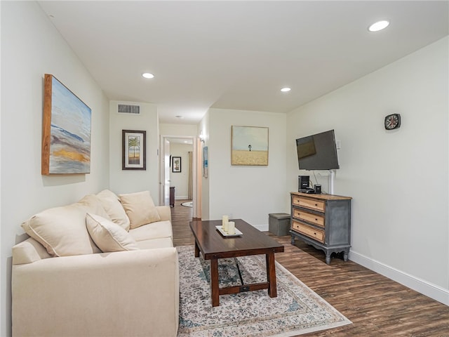 living room with dark hardwood / wood-style flooring