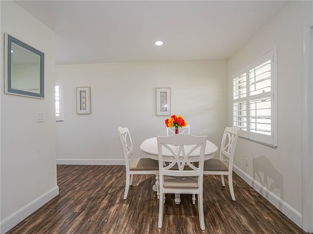 dining space with dark hardwood / wood-style flooring