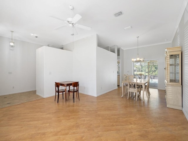 77 Joy Haven Dr, Sebastian, FL 32958 - dining area with light wood finished floors, ornamental molding, a chandelier, a ceiling fan, and high vaulted ceiling