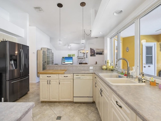 77 Joy Haven Dr, Sebastian, FL 32958 - kitchen featuring stainless steel refrigerator with ice dispenser, dishwasher, light countertops, and light tile patterned floors