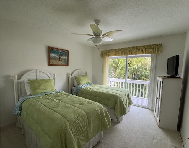 bedroom featuring access to outside, light carpet, ceiling fan, and a textured ceiling