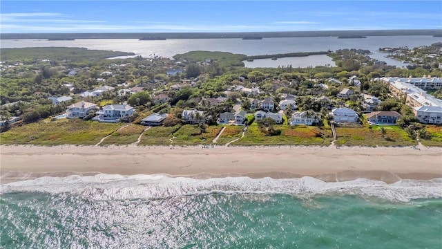 bird's eye view featuring a beach view and a water view