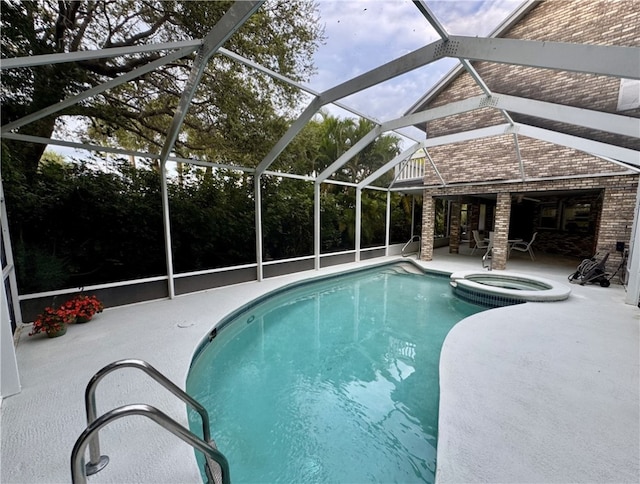 view of swimming pool with glass enclosure, a pool with connected hot tub, and a patio area