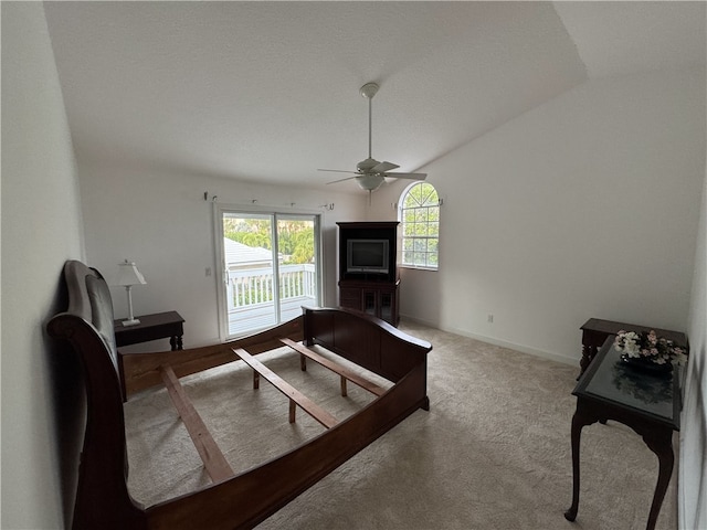 carpeted bedroom with access to exterior, baseboards, vaulted ceiling, and a ceiling fan