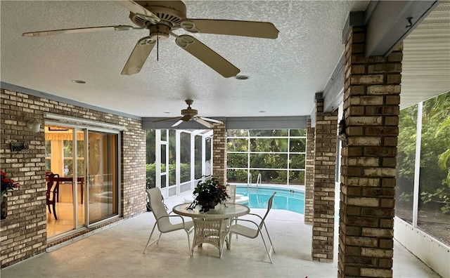 pool with a ceiling fan, a lanai, and a patio area