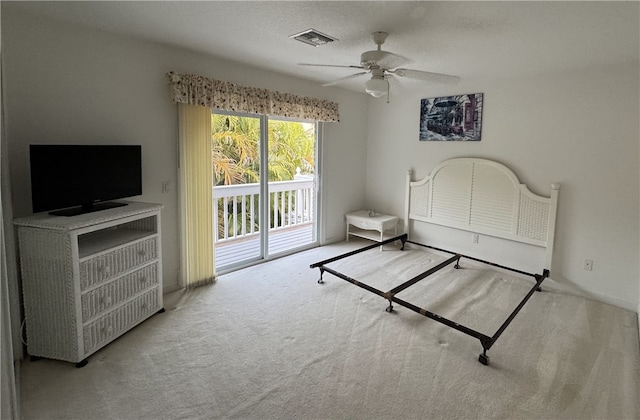 bedroom with visible vents, ceiling fan, access to outside, a textured ceiling, and carpet floors