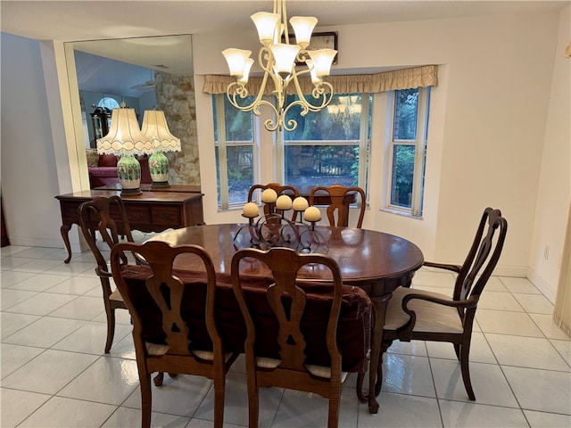 dining room with light tile patterned flooring, a notable chandelier, and baseboards