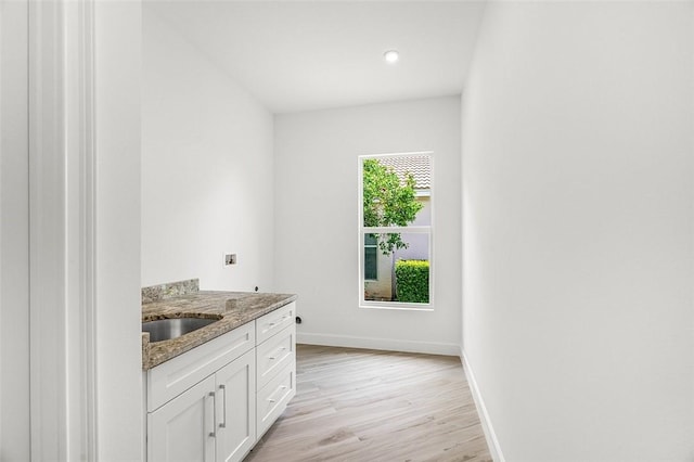 1090 Buckhead Dr SW, Vero Beach, FL 32968 - laundry room with baseboards, light wood-style flooring, recessed lighting, cabinet space, and hookup for an electric dryer