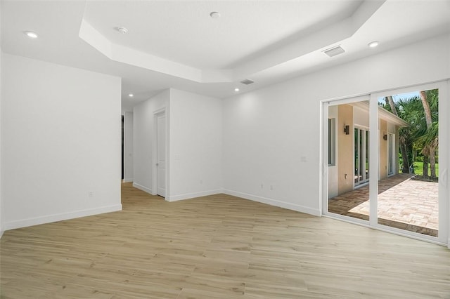 1090 Buckhead Dr SW, Vero Beach, FL 32968 - empty room with light wood-style flooring, recessed lighting, baseboards, and a raised ceiling
