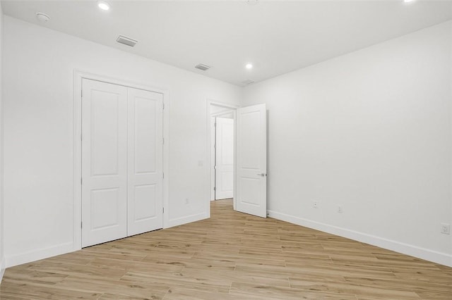 1090 Buckhead Dr SW, Vero Beach, FL 32968 - unfurnished bedroom with light wood finished floors, recessed lighting, baseboards, and a closet