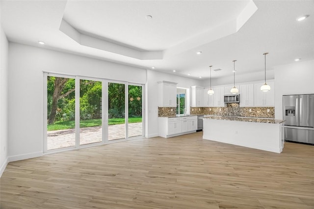 1090 Buckhead Dr SW, Vero Beach, FL 32968 - kitchen with stainless steel appliances, healthy amount of natural light, backsplash, white cabinets, and recessed lighting