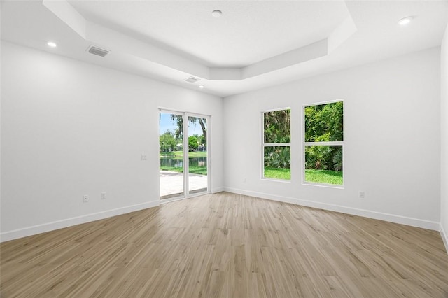 1090 Buckhead Dr SW, Vero Beach, FL 32968 - spare room featuring light wood-type flooring, baseboards, a raised ceiling, and recessed lighting
