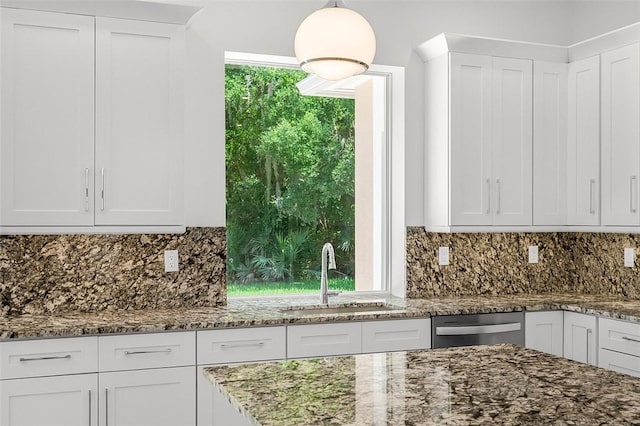 1090 Buckhead Dr SW, Vero Beach, FL 32968 - kitchen featuring a sink, dishwasher, white cabinets, dark stone countertops, and decorative backsplash