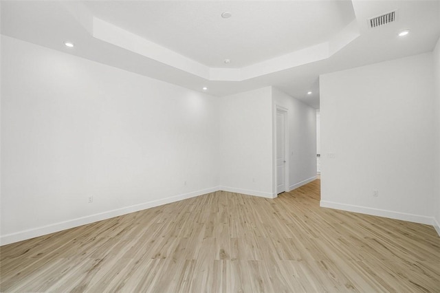 1090 Buckhead Dr SW, Vero Beach, FL 32968 - empty room featuring baseboards, a raised ceiling, light wood finished floors, and recessed lighting