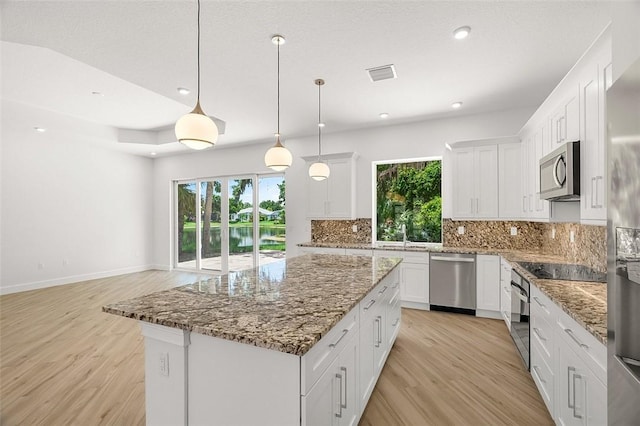 1090 Buckhead Dr SW, Vero Beach, FL 32968 - kitchen with appliances with stainless steel finishes, healthy amount of natural light, light wood-style floors, and recessed lighting