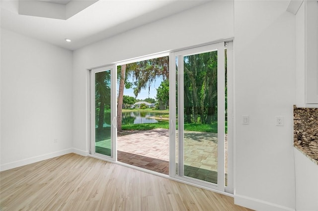 1090 Buckhead Dr SW, Vero Beach, FL 32968 - doorway featuring light wood-style floors, baseboards, a water view, and recessed lighting