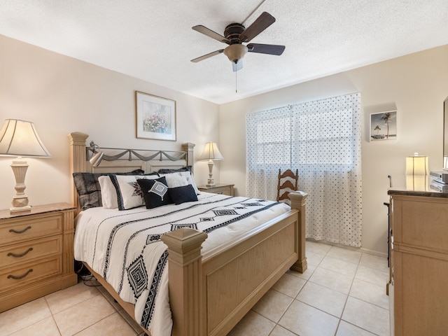 tiled bedroom with ceiling fan and a textured ceiling