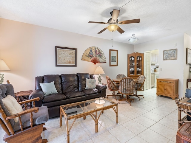 tiled living room featuring a textured ceiling and ceiling fan