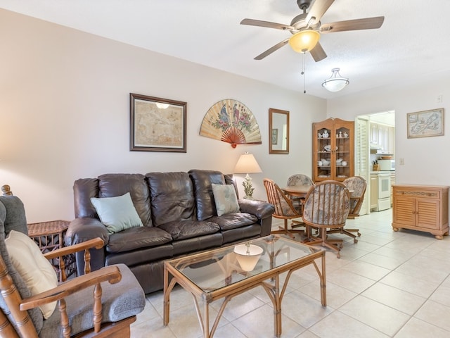 tiled living room with ceiling fan