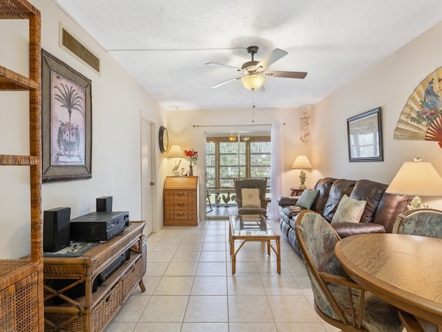 tiled living room featuring a textured ceiling and ceiling fan