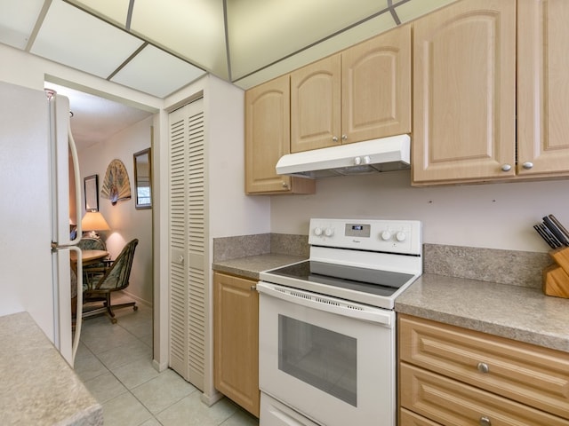 kitchen with light brown cabinets, white appliances, and light tile patterned flooring