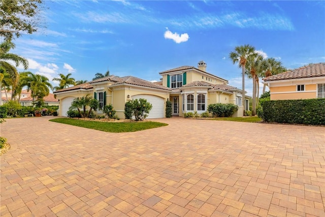 mediterranean / spanish home featuring a garage