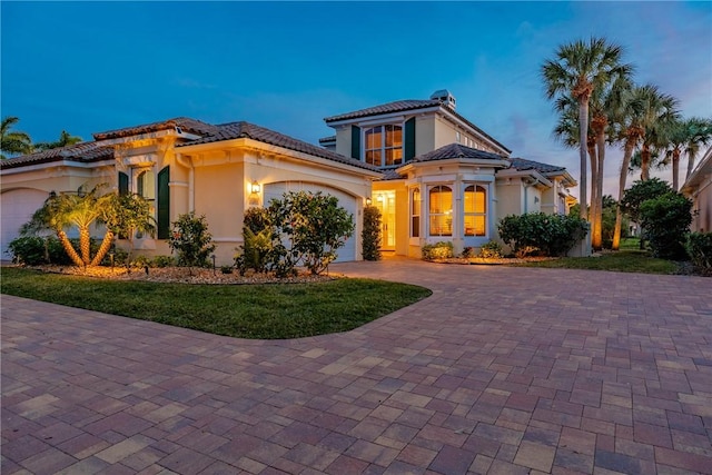 mediterranean / spanish home featuring a garage