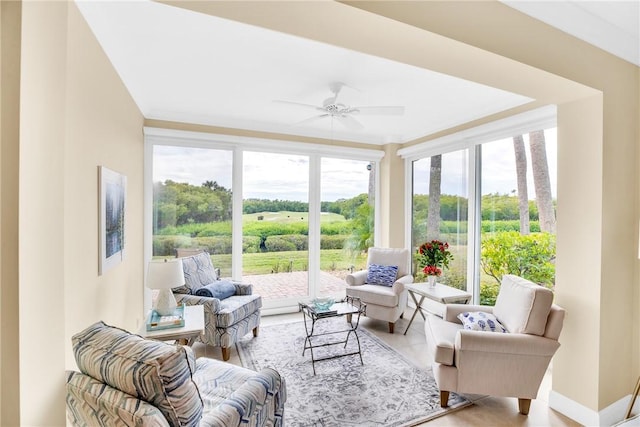 sunroom featuring ceiling fan and a healthy amount of sunlight