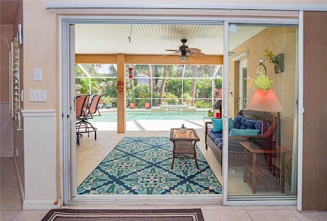 interior space with ceiling fan and tile patterned flooring