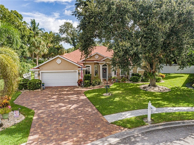 view of front of home with a garage and a front yard