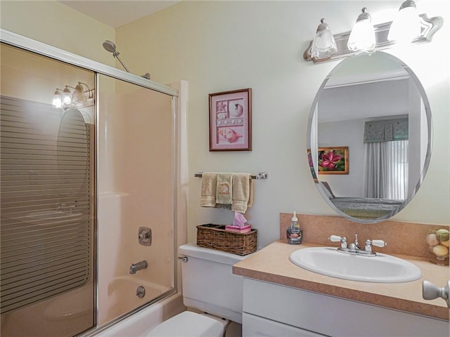 full bathroom with vanity, enclosed tub / shower combo, and toilet