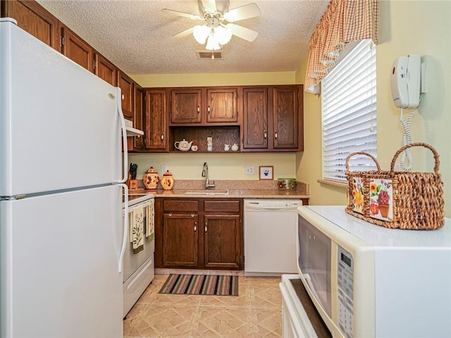 kitchen with sink, white appliances, a textured ceiling, light tile patterned floors, and ceiling fan