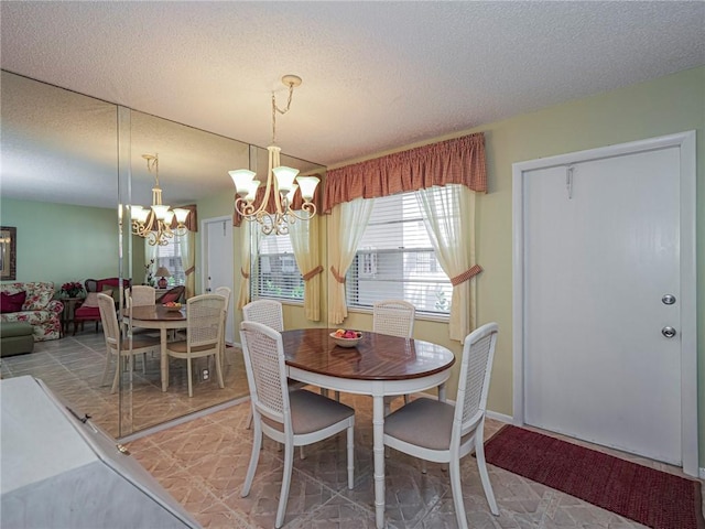 dining area featuring a textured ceiling and a notable chandelier